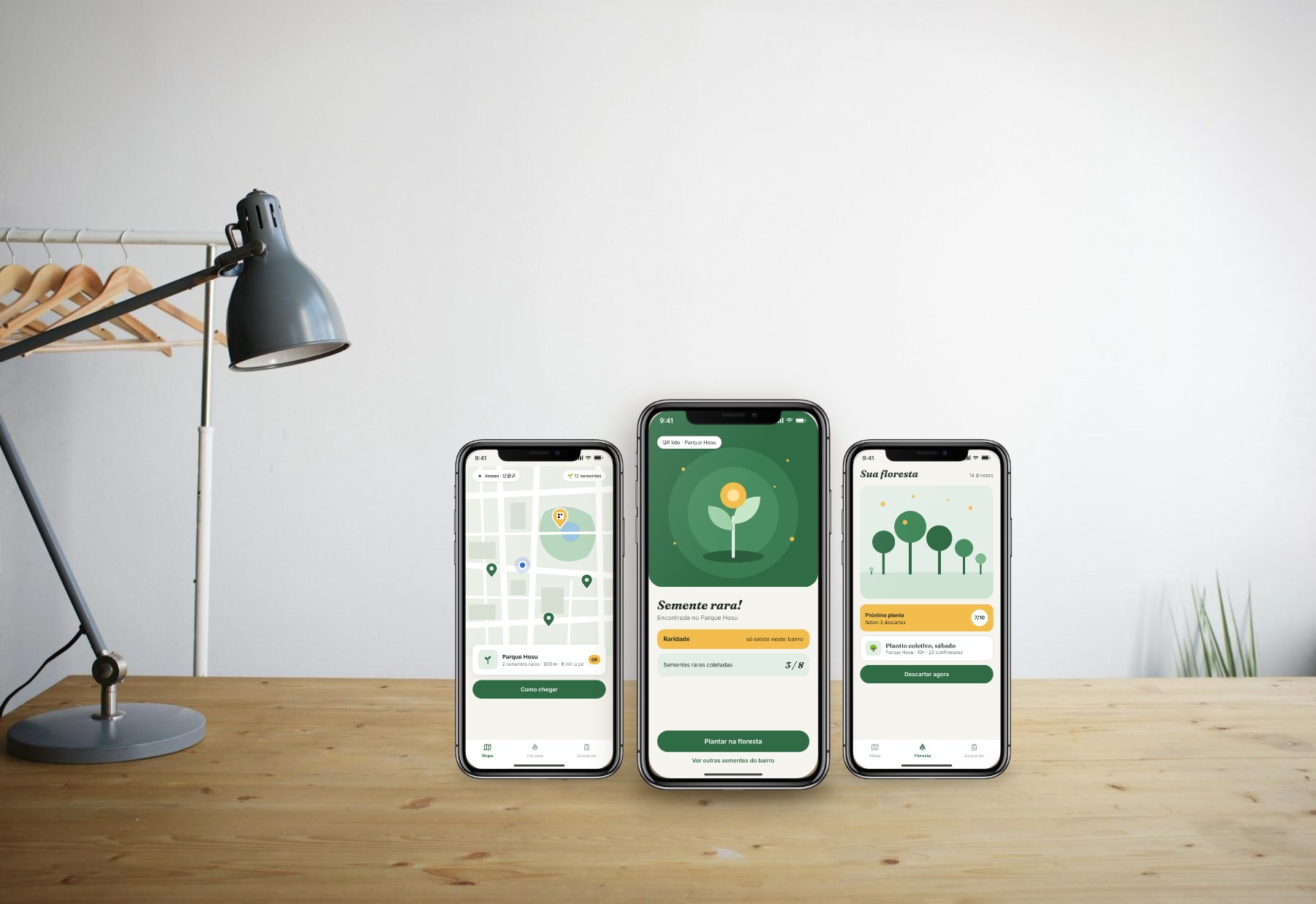 Three TrashRush screens on phones on a wooden desk